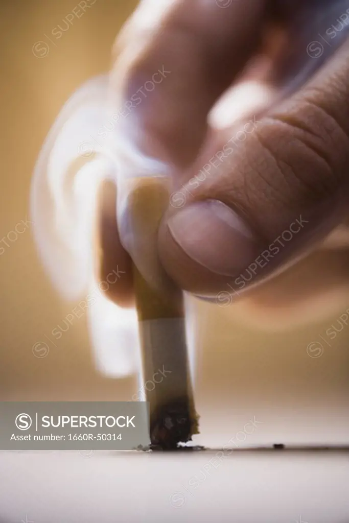 Hand butting out a cigarette