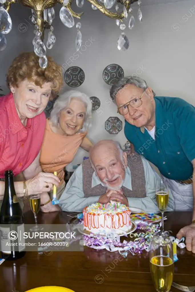 Partygoers around a birthday cake