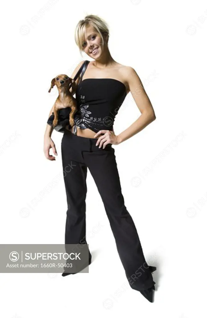Woman with a small dog in her purse