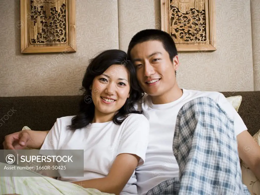 Couple in bed hugging and smiling
