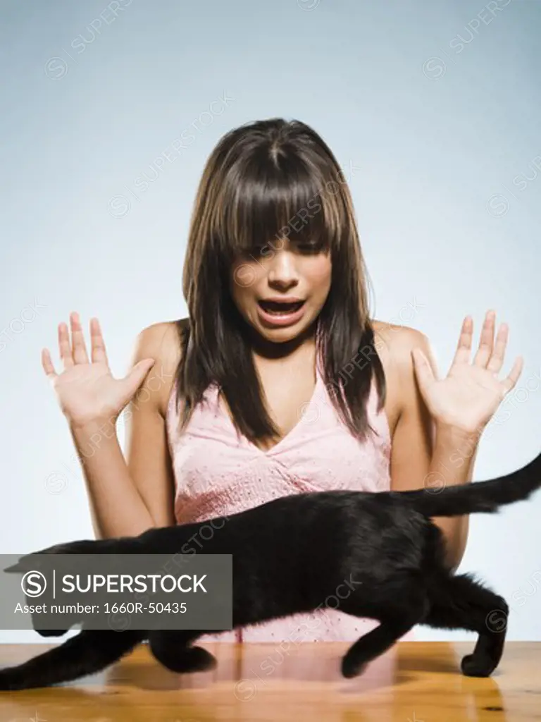 Woman with black kitten scared