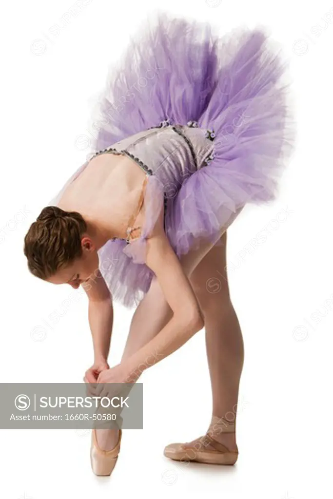 Ballet dancer adjusting slipper