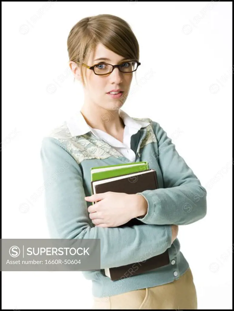 Young woman posing with books
