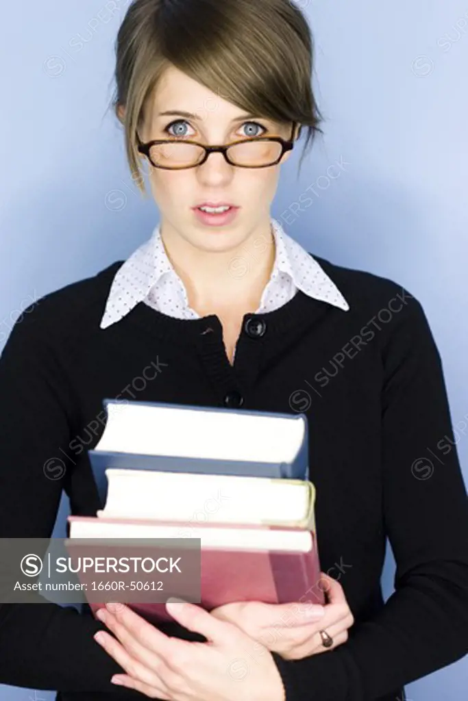 Young woman posing with books