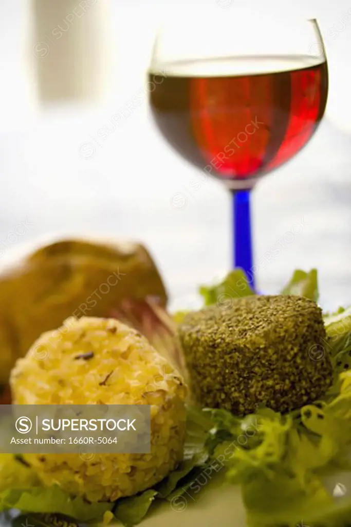 Close-up of a wine glass with a plate of goat cheese