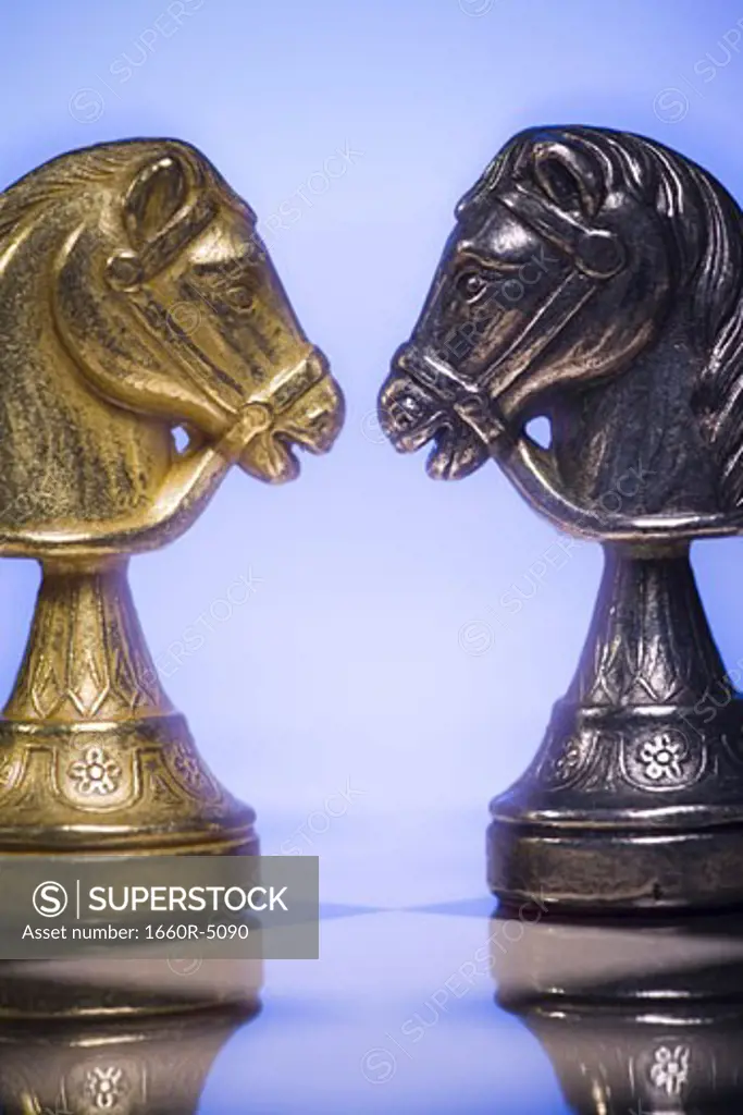 Close-up of chess pieces facing each other