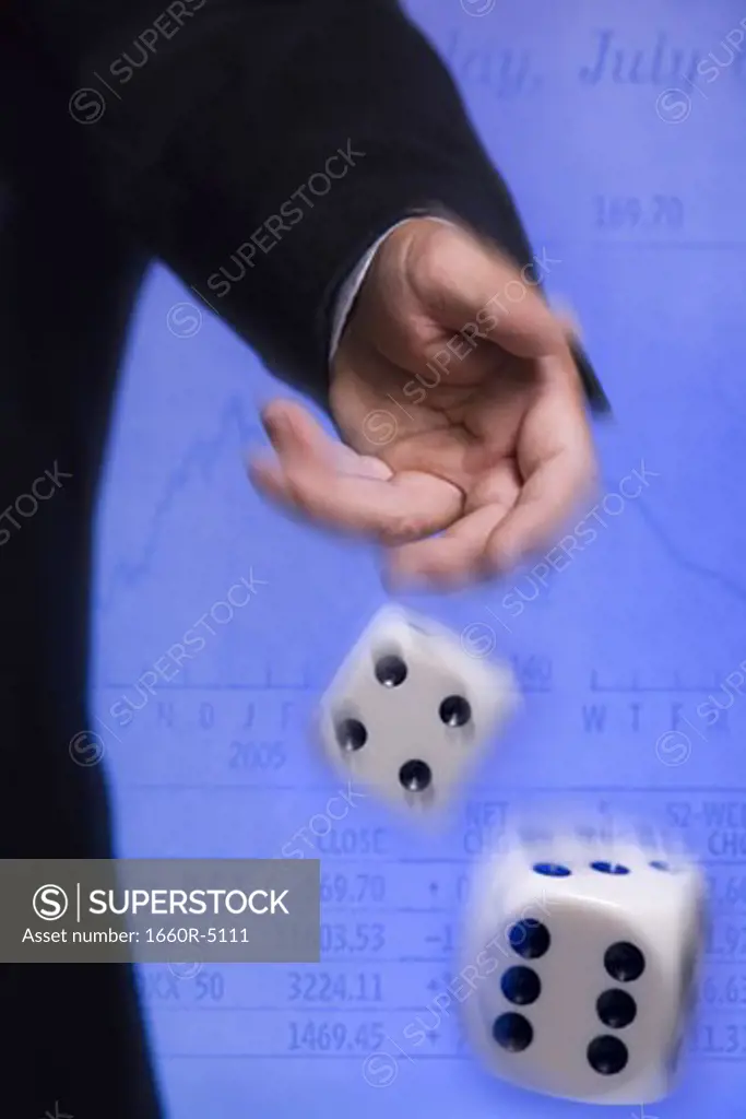 Close-up of a person's hand rolling a pair of dice
