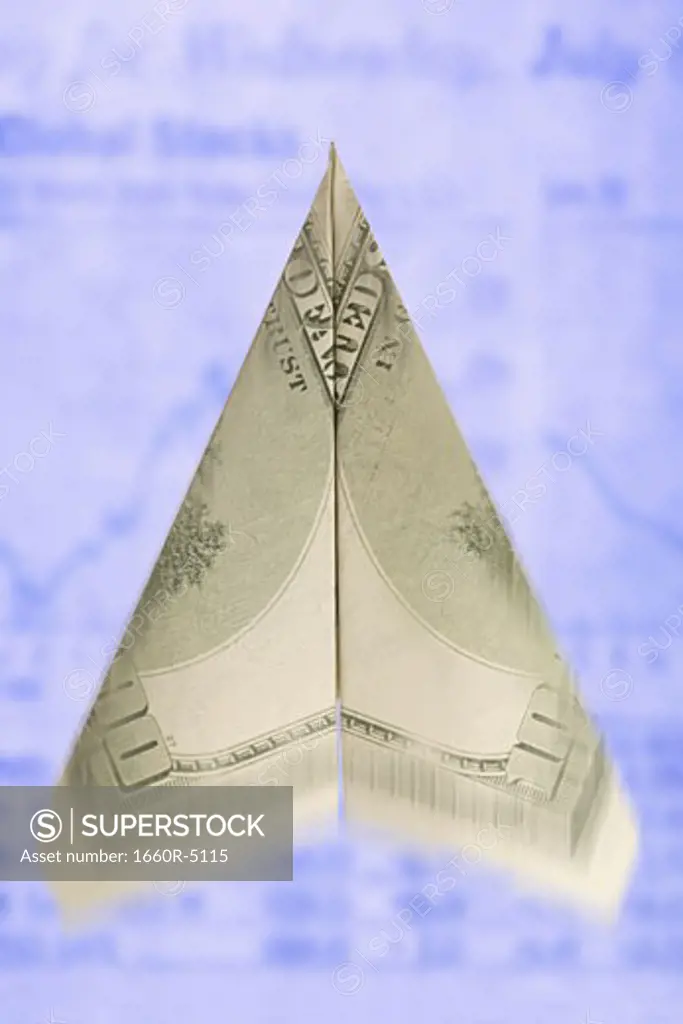 Close-up of a paper airplane made from a one hundred dollar bill