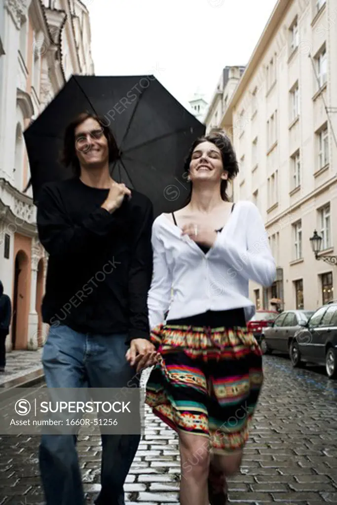 Couple in the rain holding hands