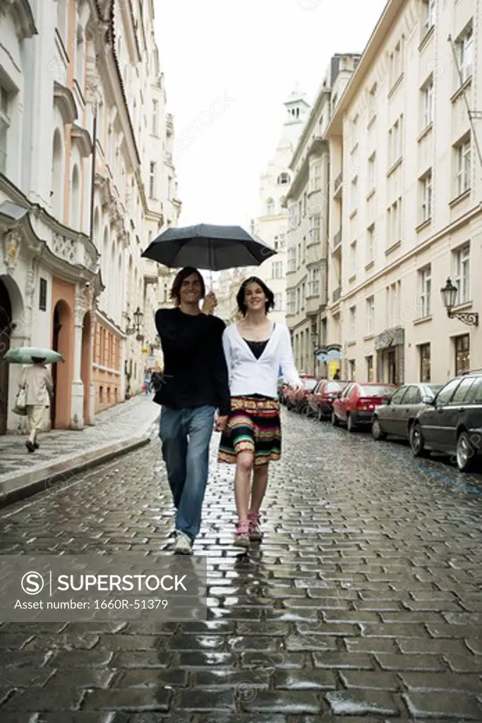 Couple in the rain holding hands