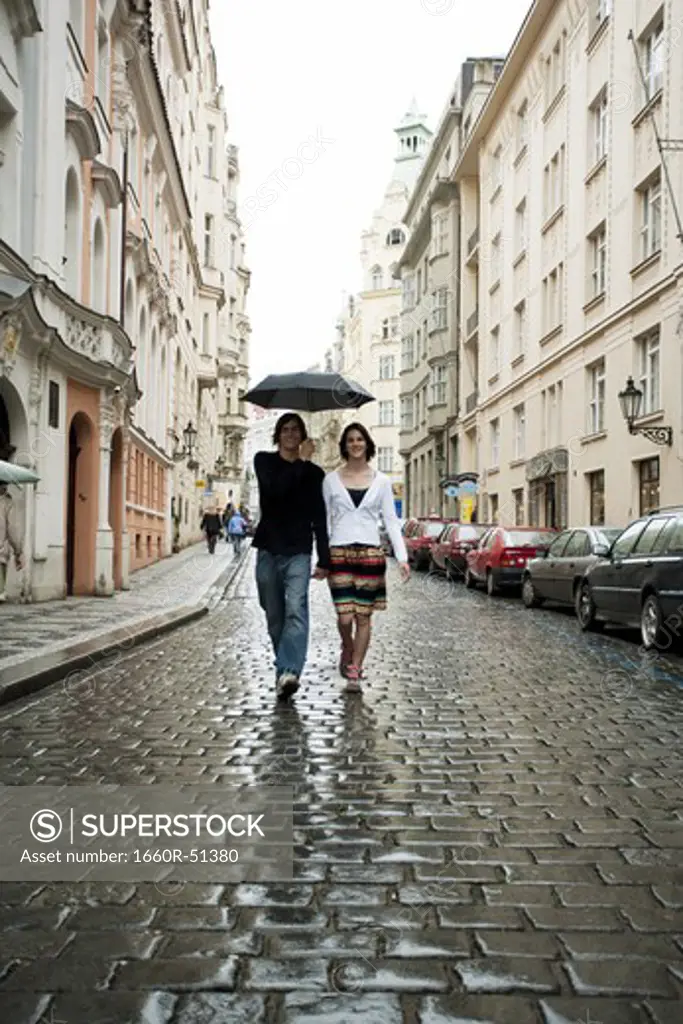 Couple in the rain holding hands