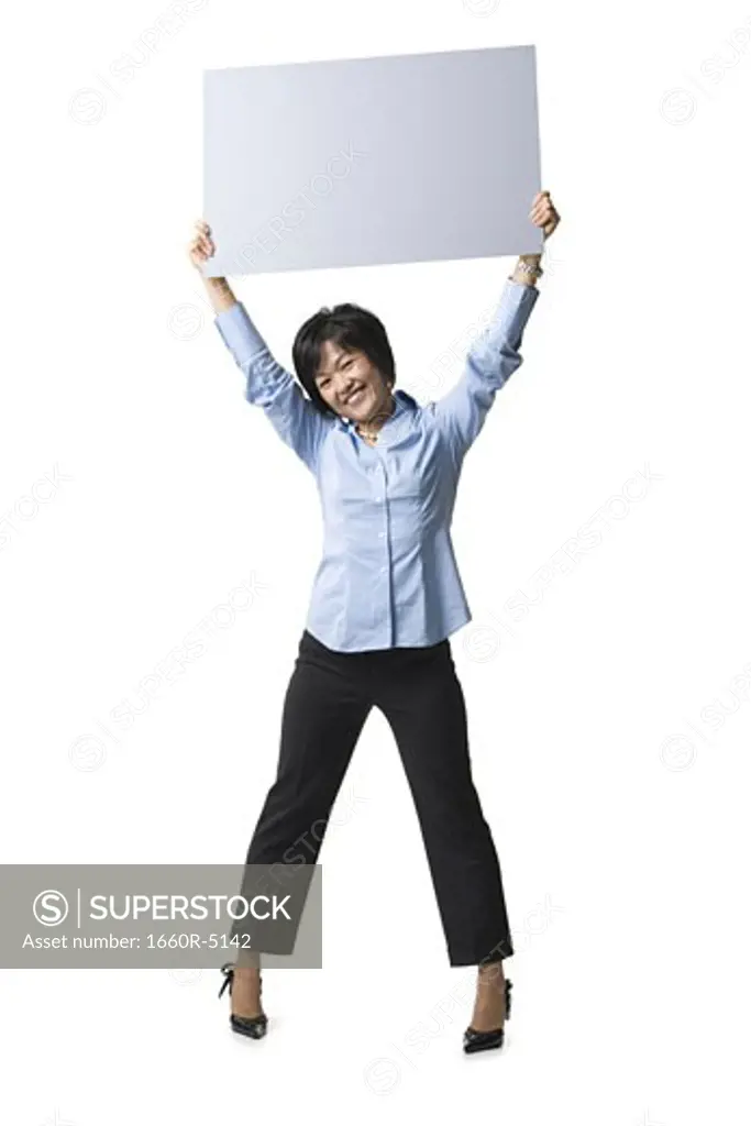 Portrait of a mid adult woman holding up a blank sign