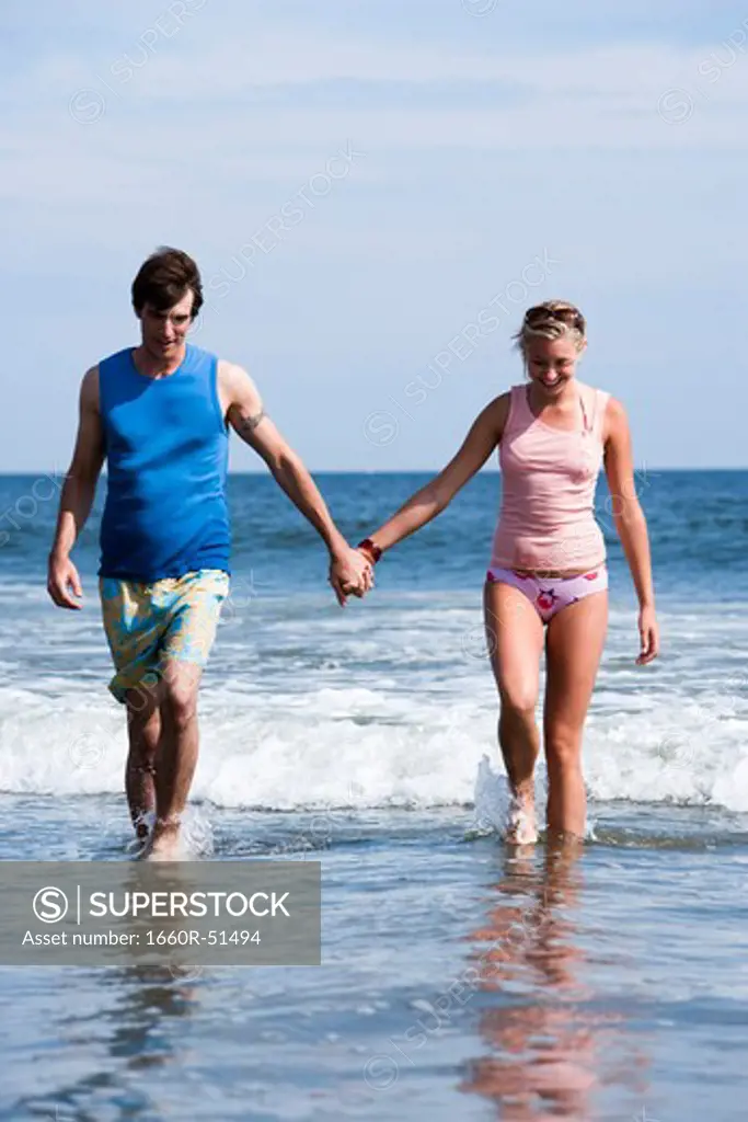 Couple holding hands at the beach