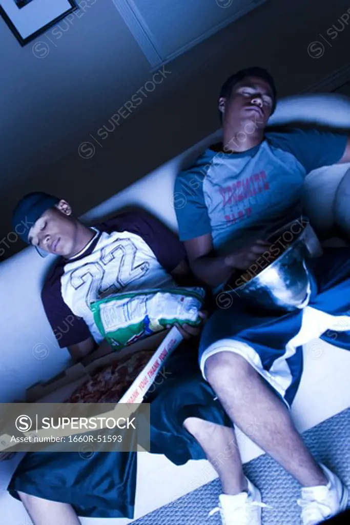 Friends sleeping on a couch