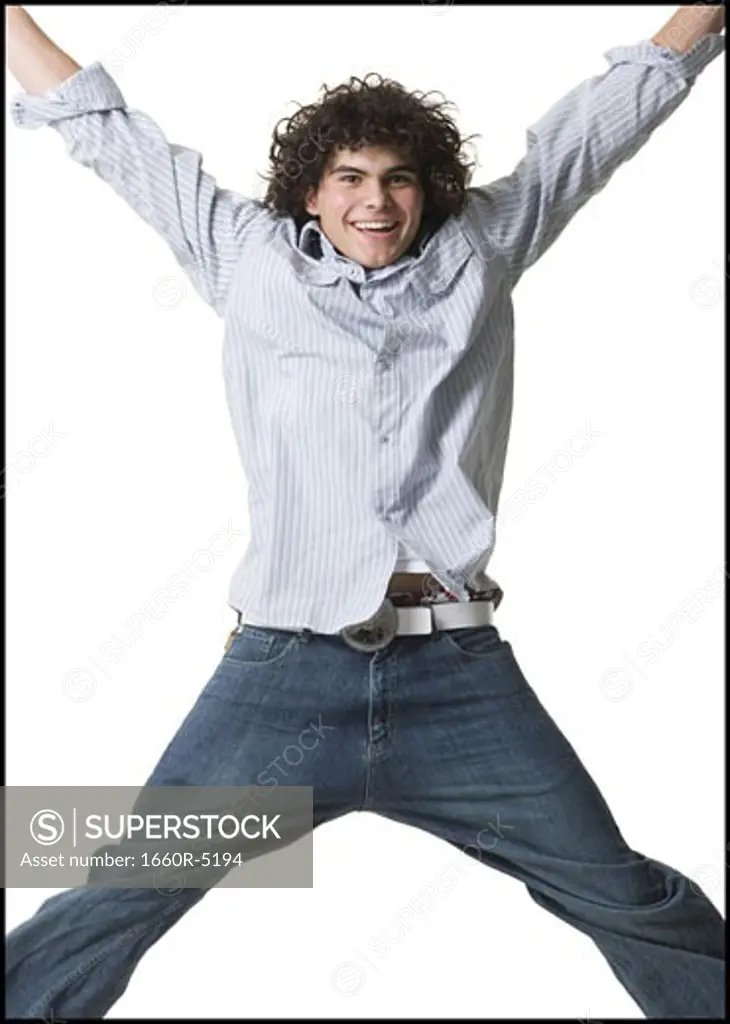 Portrait of a teenage boy jumping in mid-air