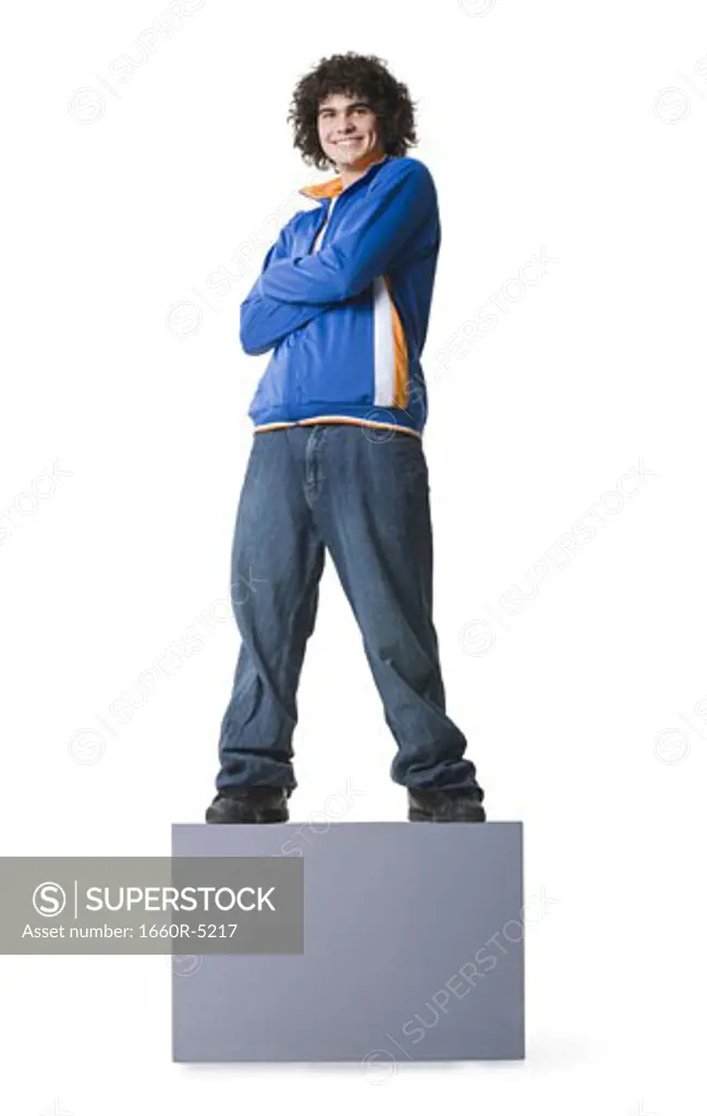 Portrait of a teenage boy standing on a blank sign