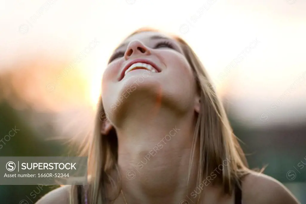 Teenage girl looking up smiling