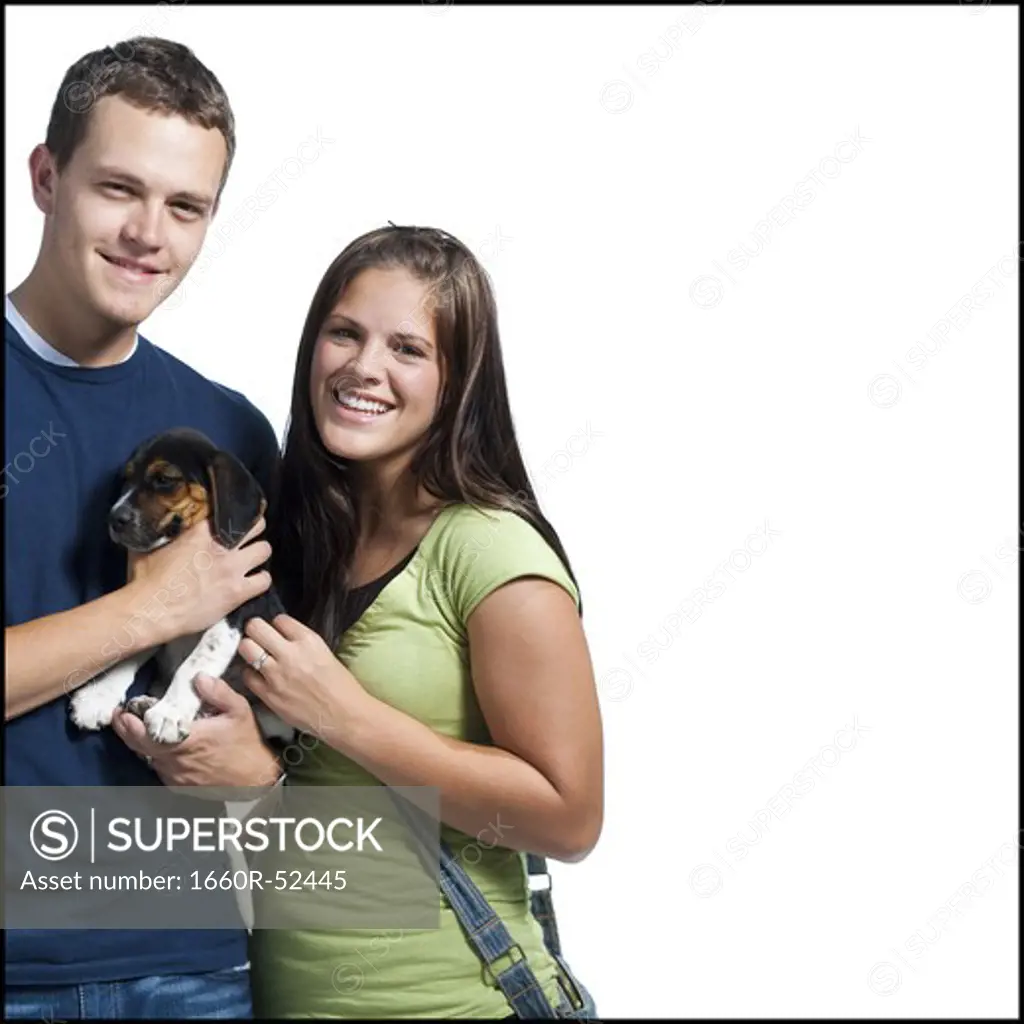 Young couple holding a beagle
