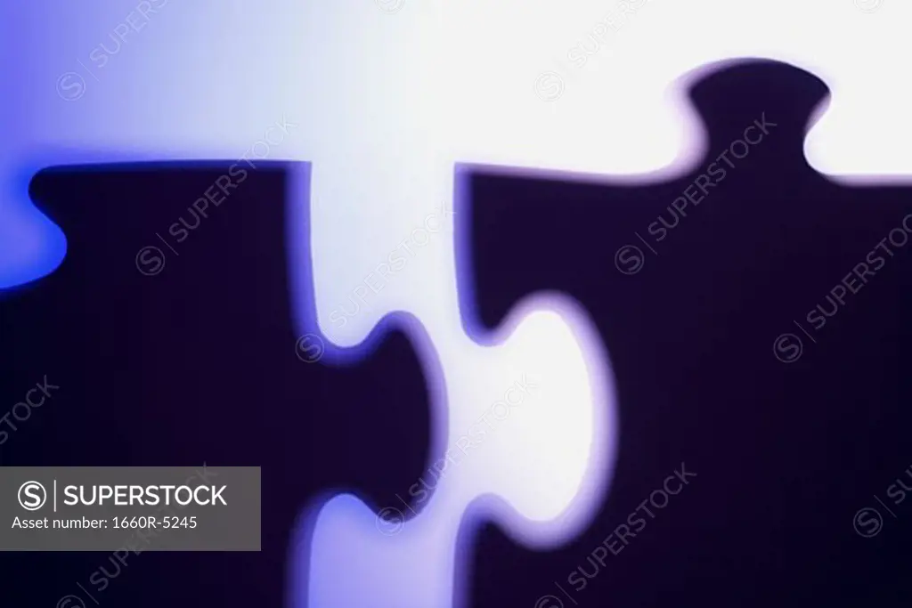 Close-up of two jigsaw puzzle pieces