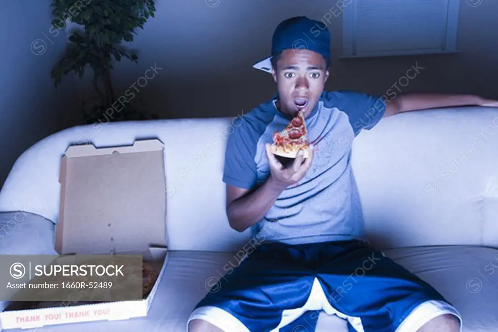 Teenage boy eating  popcorn