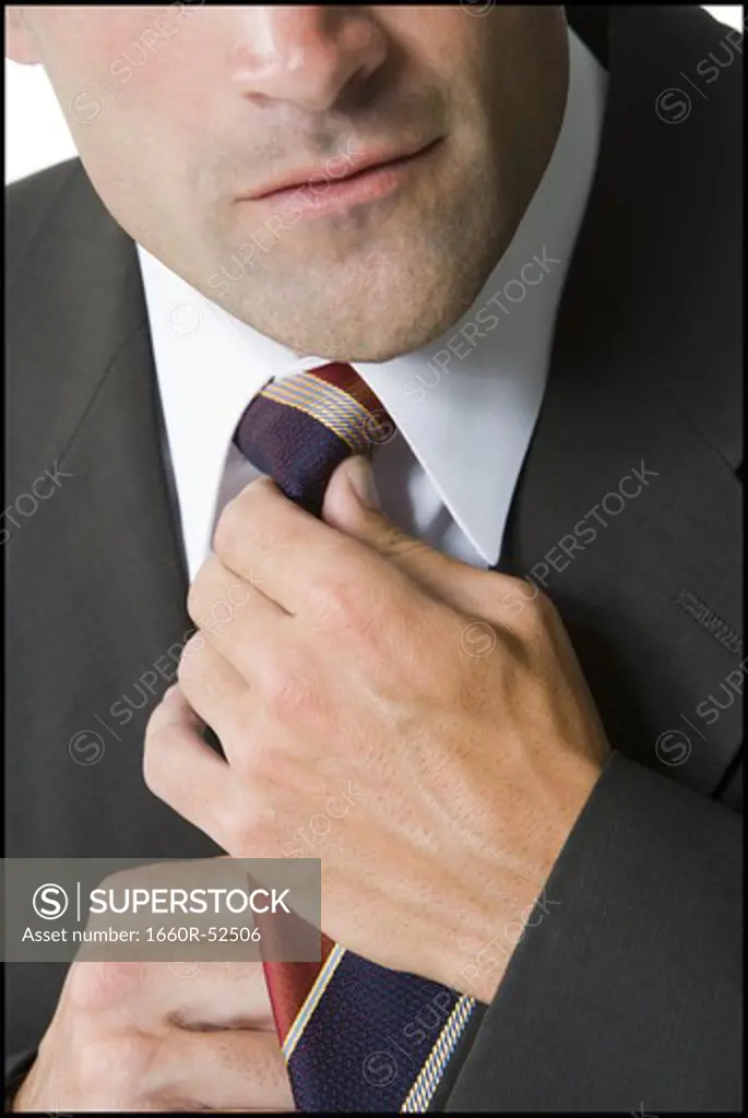 Businessman fixing his tie