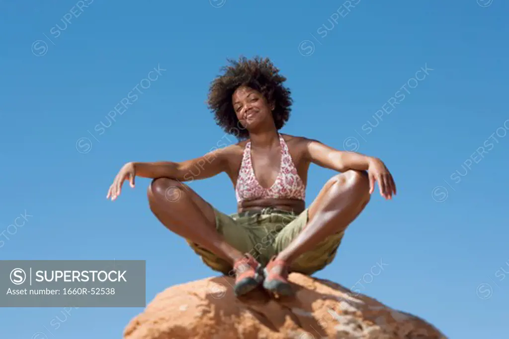 Woman on large boulder