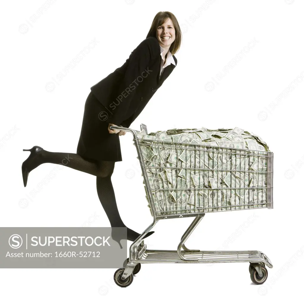 woman with a shopping cart full of money