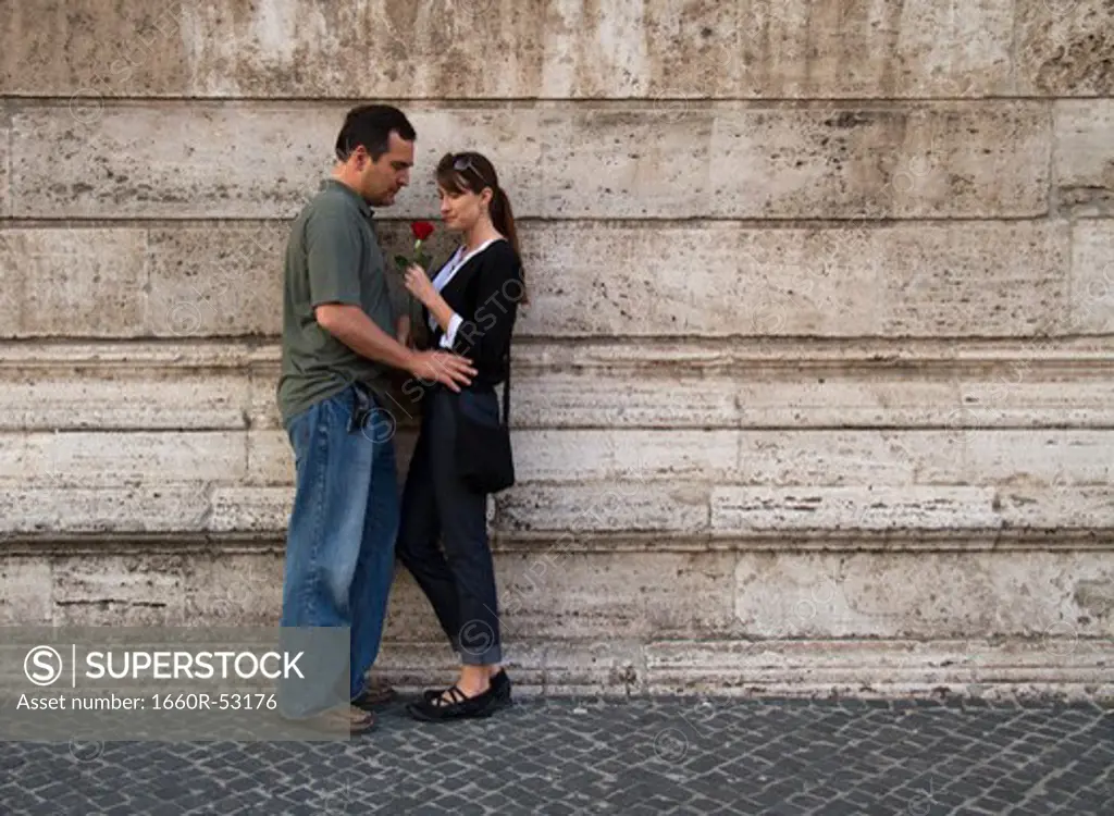 Italy, Rome, Vatican City, Romantic couple standing at wall
