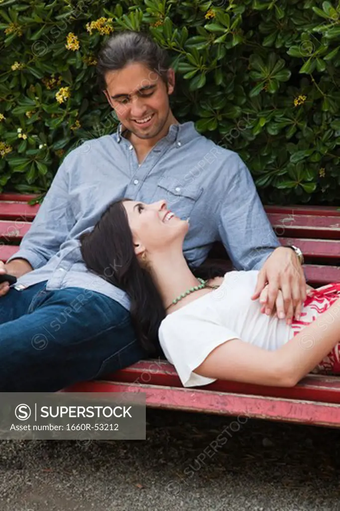 Italy, Venice, Young couple relaxing on bench