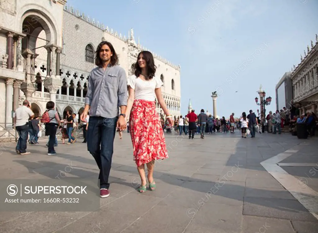 Italy, Venice, Young couple walking on St. Mark's Square