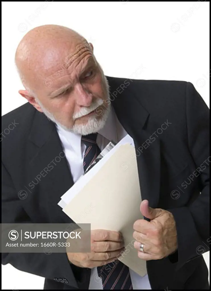 Close-up of a businessman putting papers inside his coat