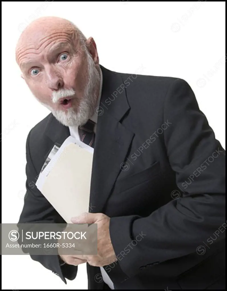 Portrait of a businessman putting papers inside his coat