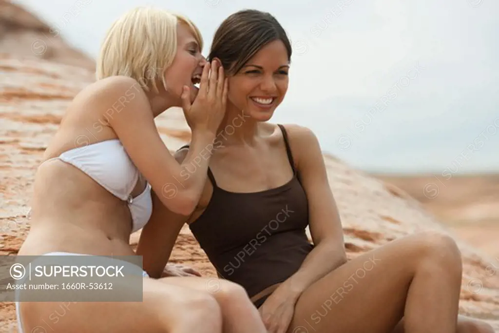 Women in swimsuits gossiping