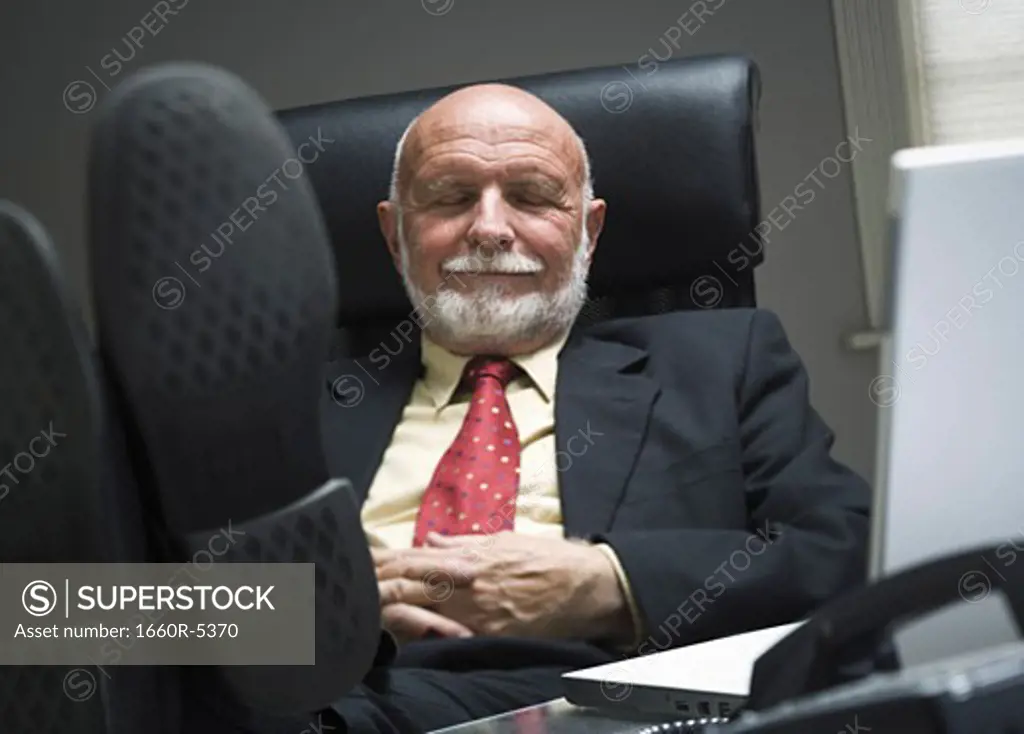 Close-up of a businessman resting in an office