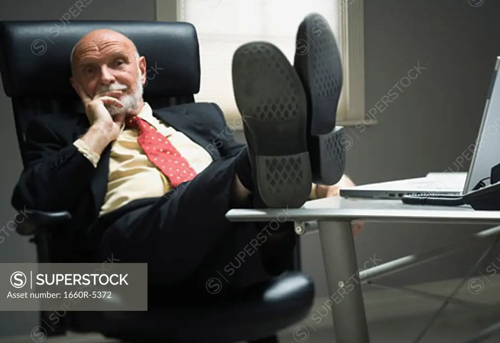 Portrait of a businessman resting in an office