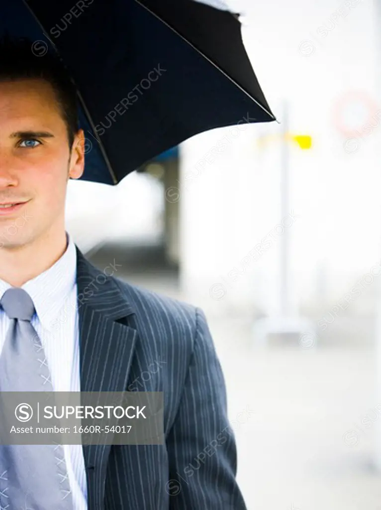 Closeup of man with umbrella