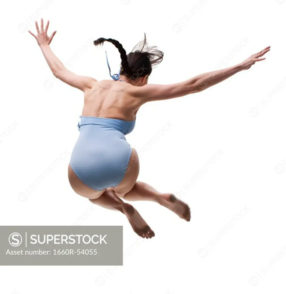 Woman jumping off dock