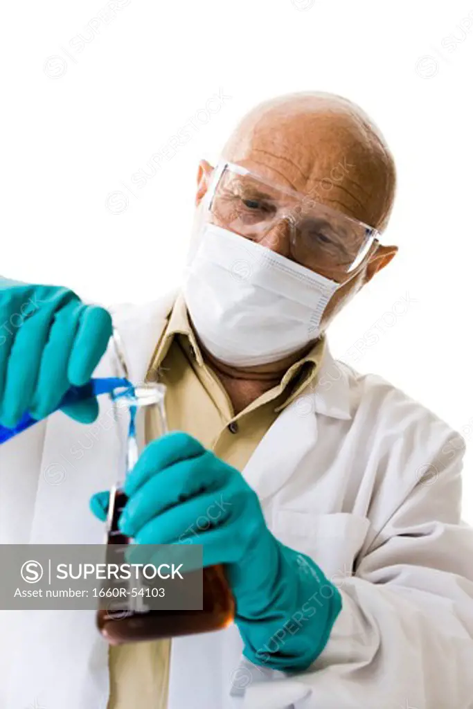 Scientist pouring chemicals into beaker