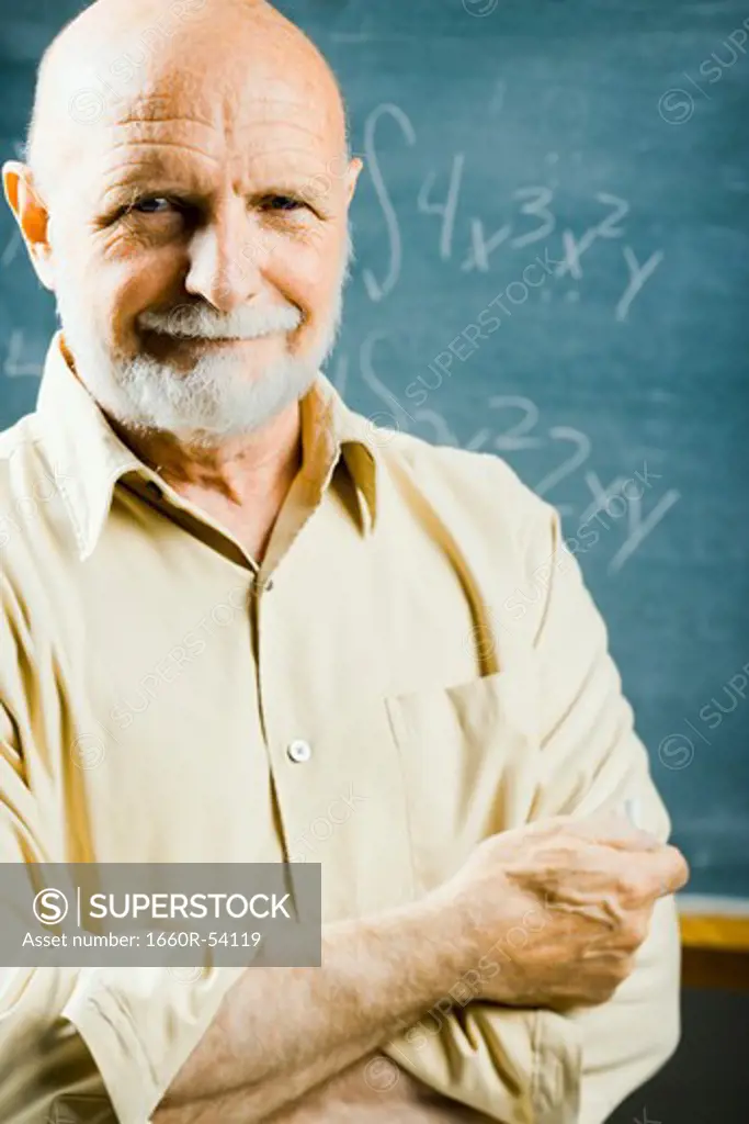 Closeup of male school teacher holding chalk