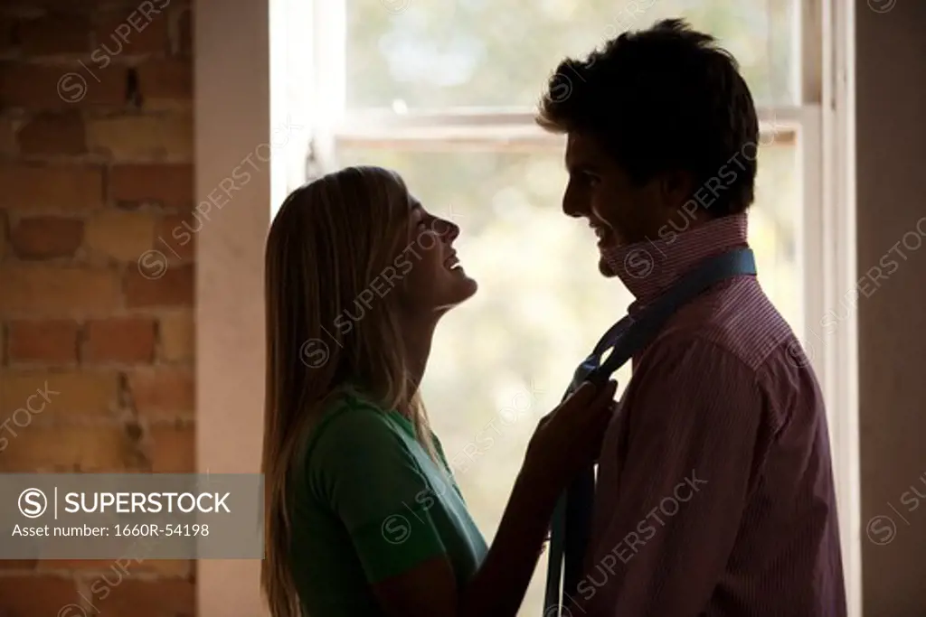 Girlfriend holding boyfriend's necktie