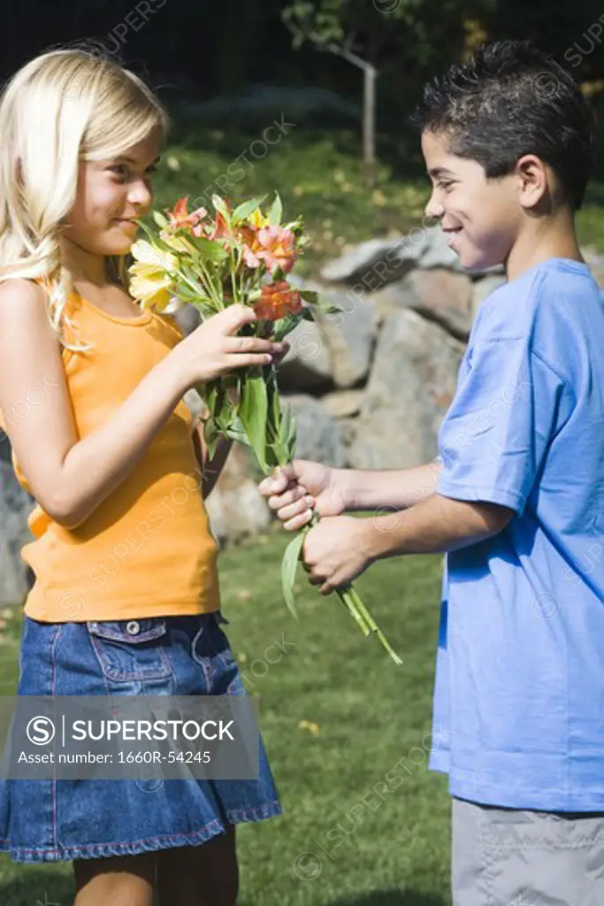 Boy giving girl flowers