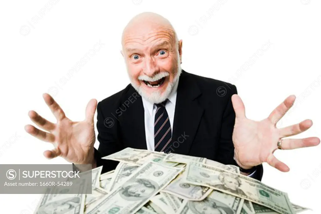 Closeup of businessman looking at pile of money