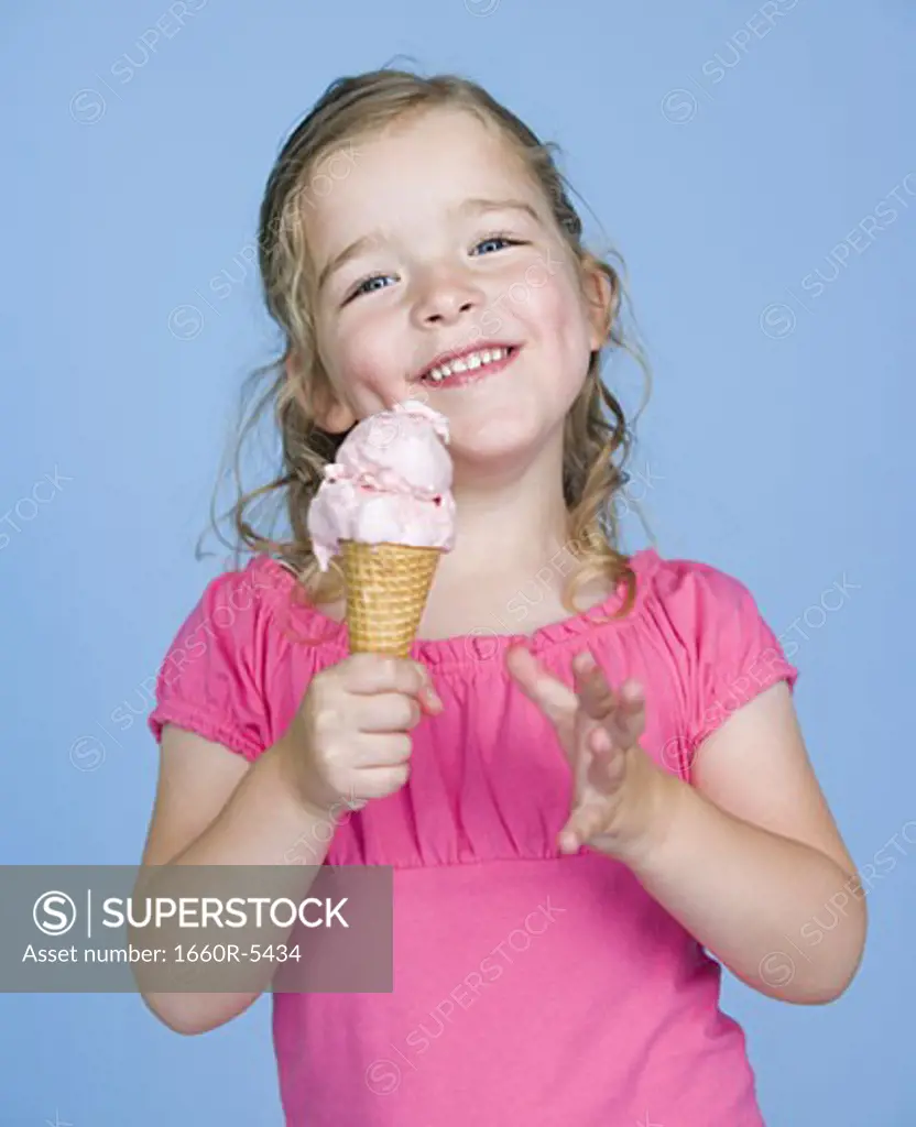 Close-up of a girl holding an ice-cream and smiling