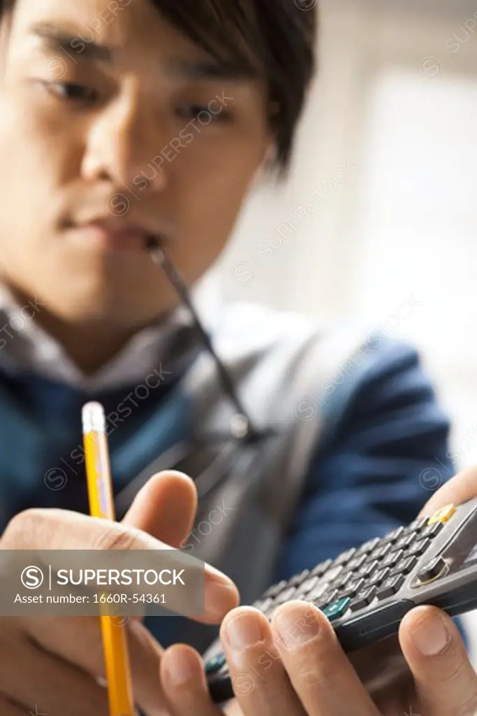 Closeup of student with calculator