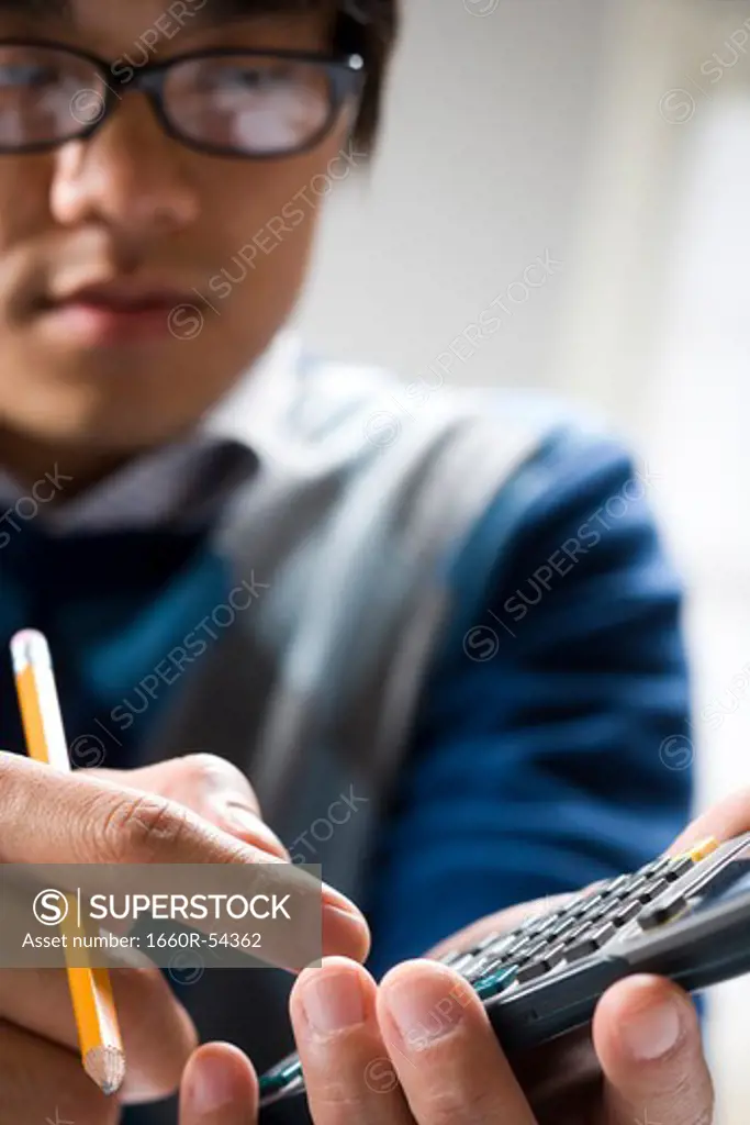 Closeup of student with calculator