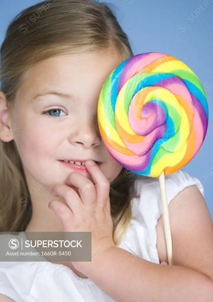Portrait of a girl holding a lollipop