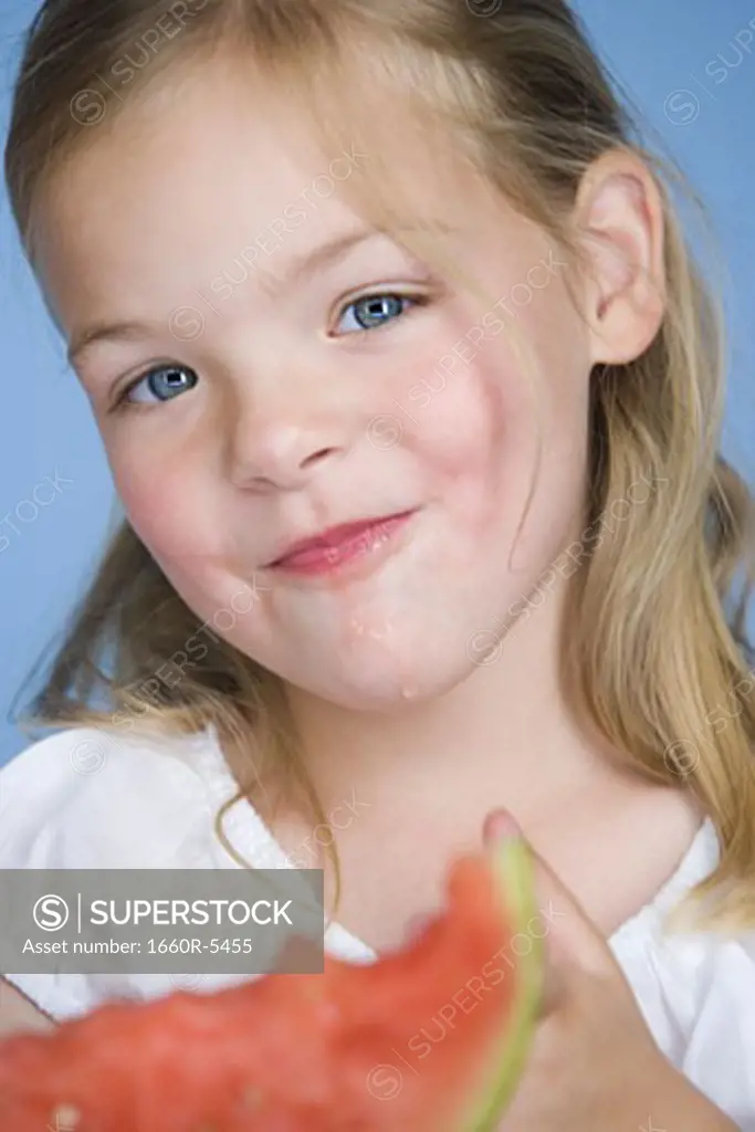 Portrait of a girl eating a watermelon