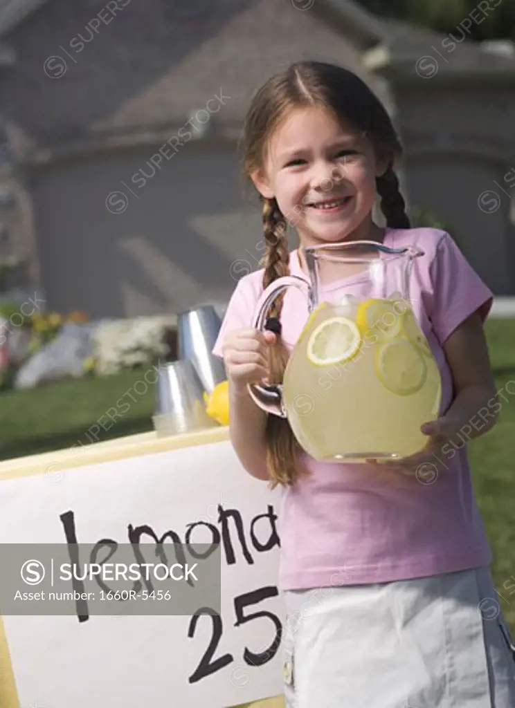 Portrait of a girl holding a jar of lemonade