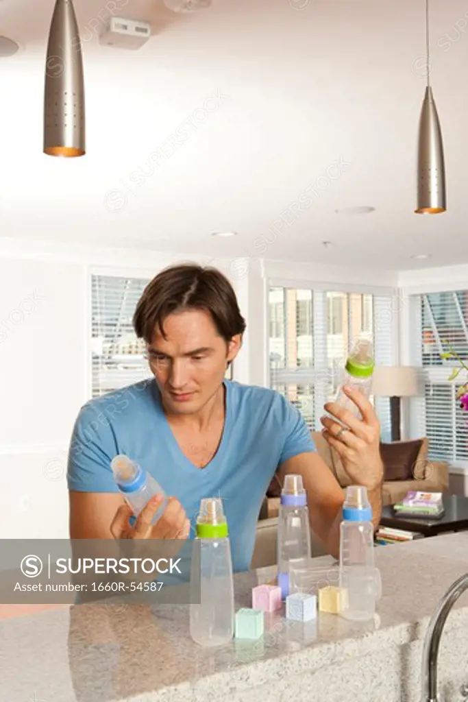 Man with baby bottles and blocks