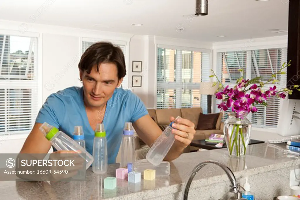 Man with baby bottles and blocks